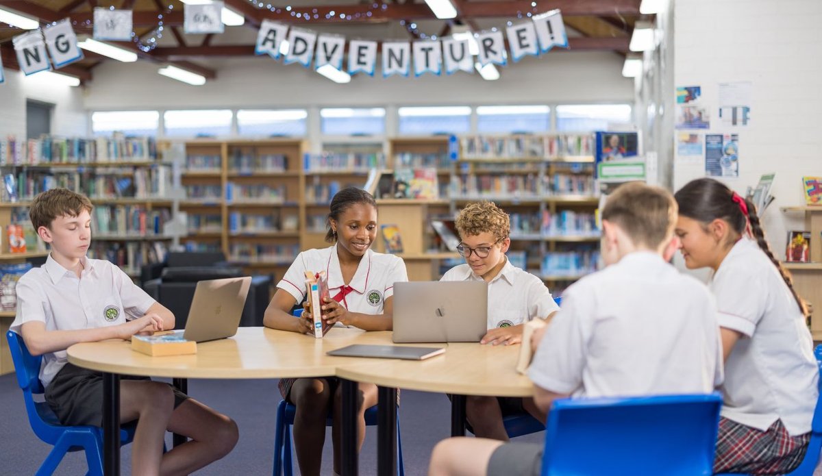 Students interacting in the school library.